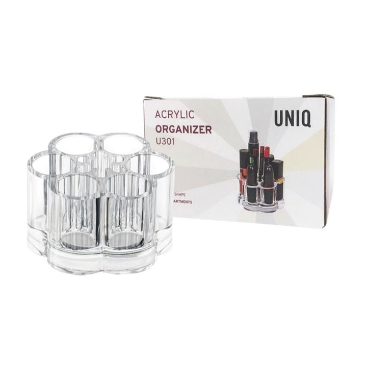 En klar UNIQ Blomster Makeup Akryl Organizer | U301 med seks rum vises ved siden af sin brandede æske, som viser et billede af organizeren med forskellige flasker.