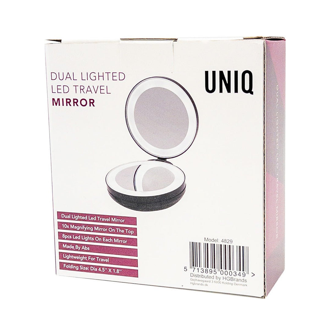 En sort UNIQ-æske til UNIQ Kompakt Dobbelt Rejsespejl med LED og x10 Forstørrelse viser det åbne runde spejl. Teksten fremhæver LED-lys, x10-forstørrelse, bærbart design og letvægts-ABS-materiale.