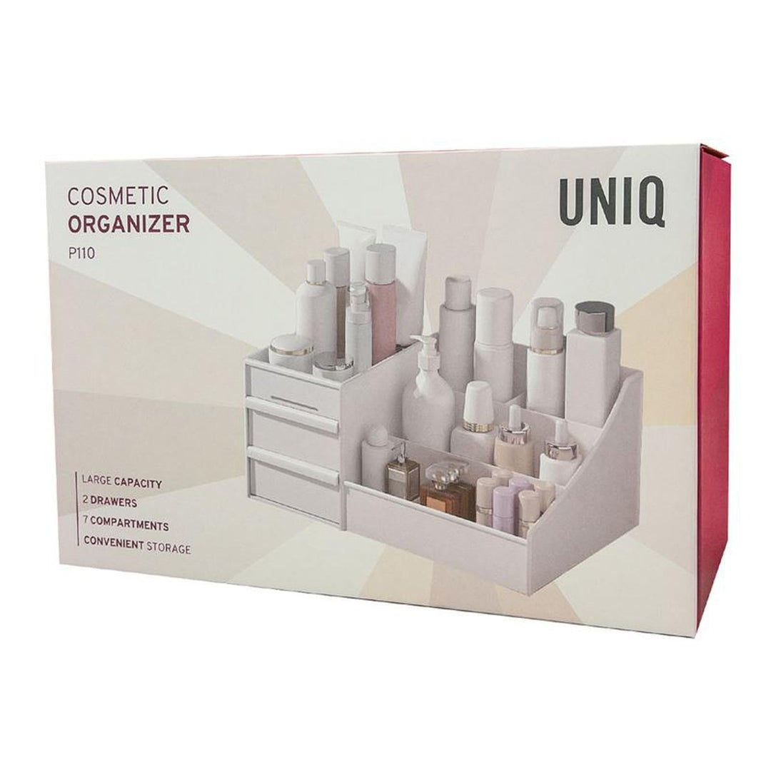 En hvid æske mærket UNIQ Kosmetik Organizer | P110 | Hvid viser et foto af en makeup-organizer med flere rum fra UNIQ og fremhæver funktioner som stor kapacitet, 2 skuffer, 7 rum og praktisk opbevaring.