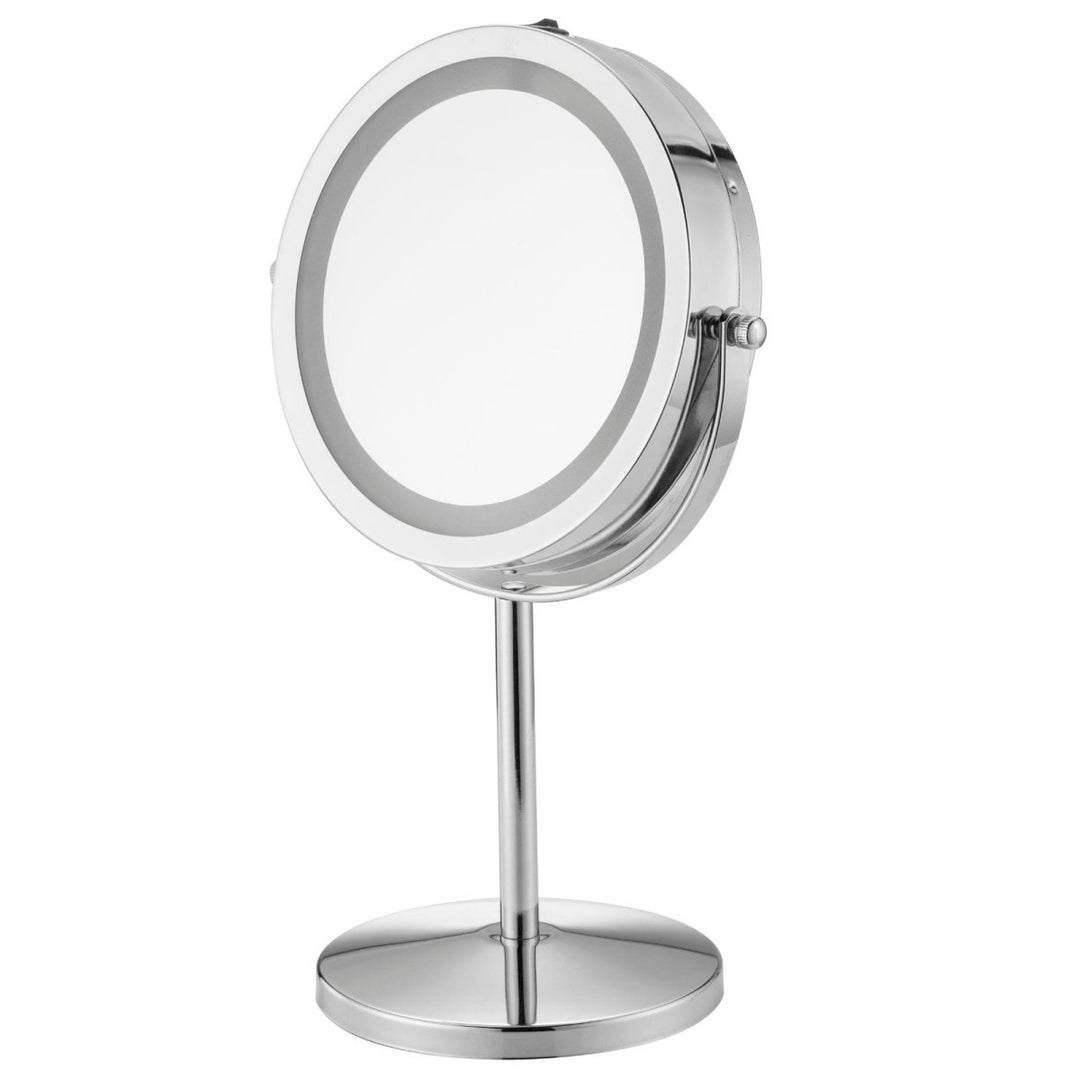 UNIQ Makeup Spejl med Lys | Large Deluxe fra UNIQ er et rundt, sølvfarvet spejl med stativ og drejeligt design, der har en oplyst LED-lysring rundt om kanten til fejlfri påføring af makeup.