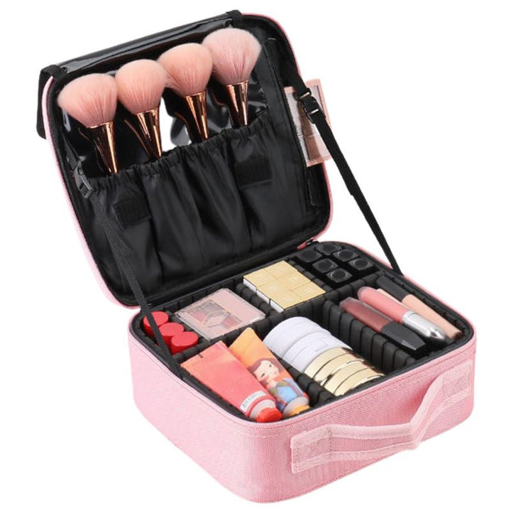 The UNIQ Rejsetoilettaske / Kosmetiktaske til alt dit Makeup i pink fra UNIQ er åben og viser rum med makeupbørster, læbestifter, pudder og paletter. Børsterne sidder i elastikstropper i låget-ideel og stilfuld opbevaring til makeup.
