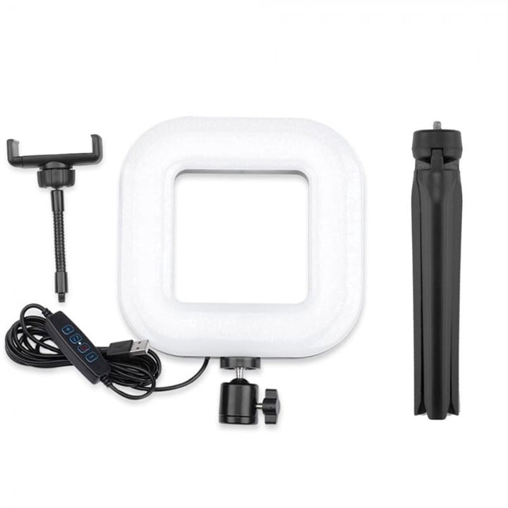 UNIQ Selfie Ringlight til iPhone og Android fra UNIQ med LED-belysning, USB-kabel, kontrolknapper, mobilholder og sort foldbart stativ - alt vist på hvid baggrund.