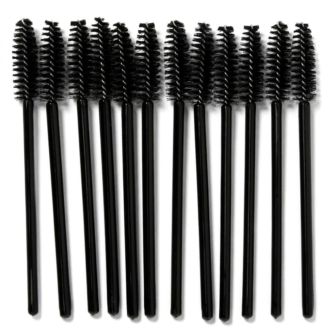 Ti sorte mascara-børster fra Technique PRO, »Øjenvippebørster – sort, 10 stk.«, er anbragt på række på en hvid baggrund og fremviser de perfekte børster til påføring af mascara eller pleje af øjenvippeforlængelser.