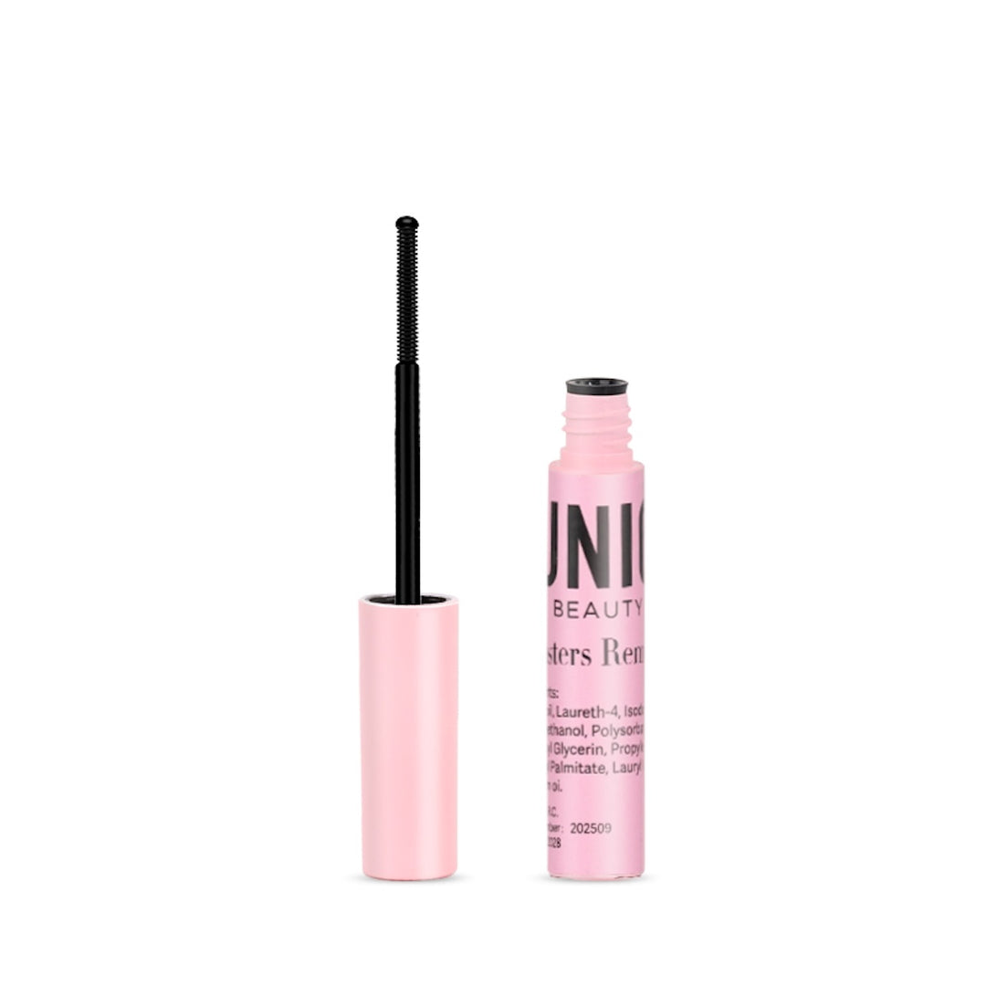 En pink UNIQ Lash Extension Starter Kit-tube fra Stylemekka.dk står åben med staven oprejst og viser sorte børstehår - ideel til at forberede vipperne, før man påsætter klyngevipper. Noget produkttekst er synlig på tuben.